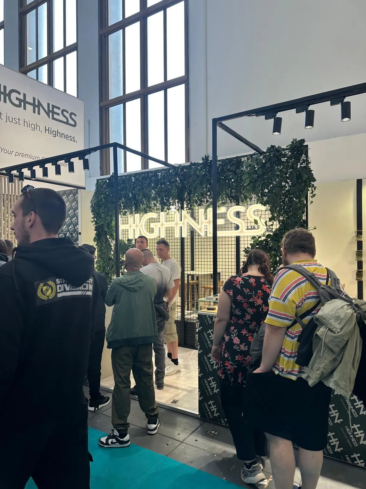 Highness booth entrance with a greenery archway at Mary Jane Berlin 2026